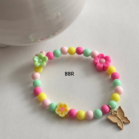 Colorful beaded bracelet with flower beads, and a gold butterfly charm.