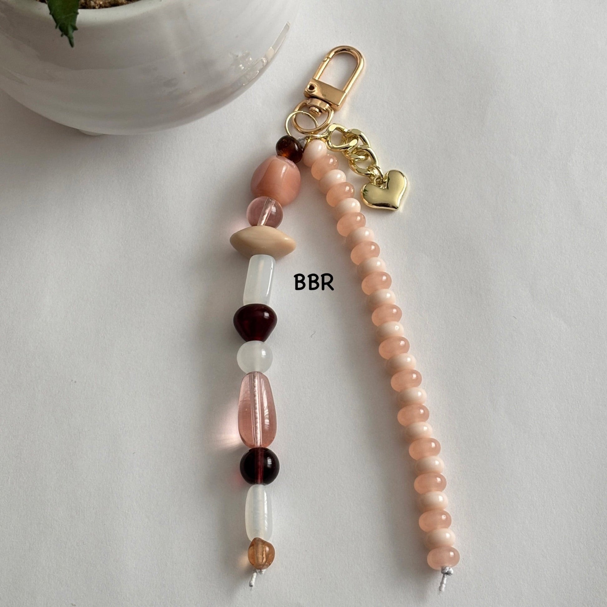 Handmade beaded bag charm with a gold link heart charm.