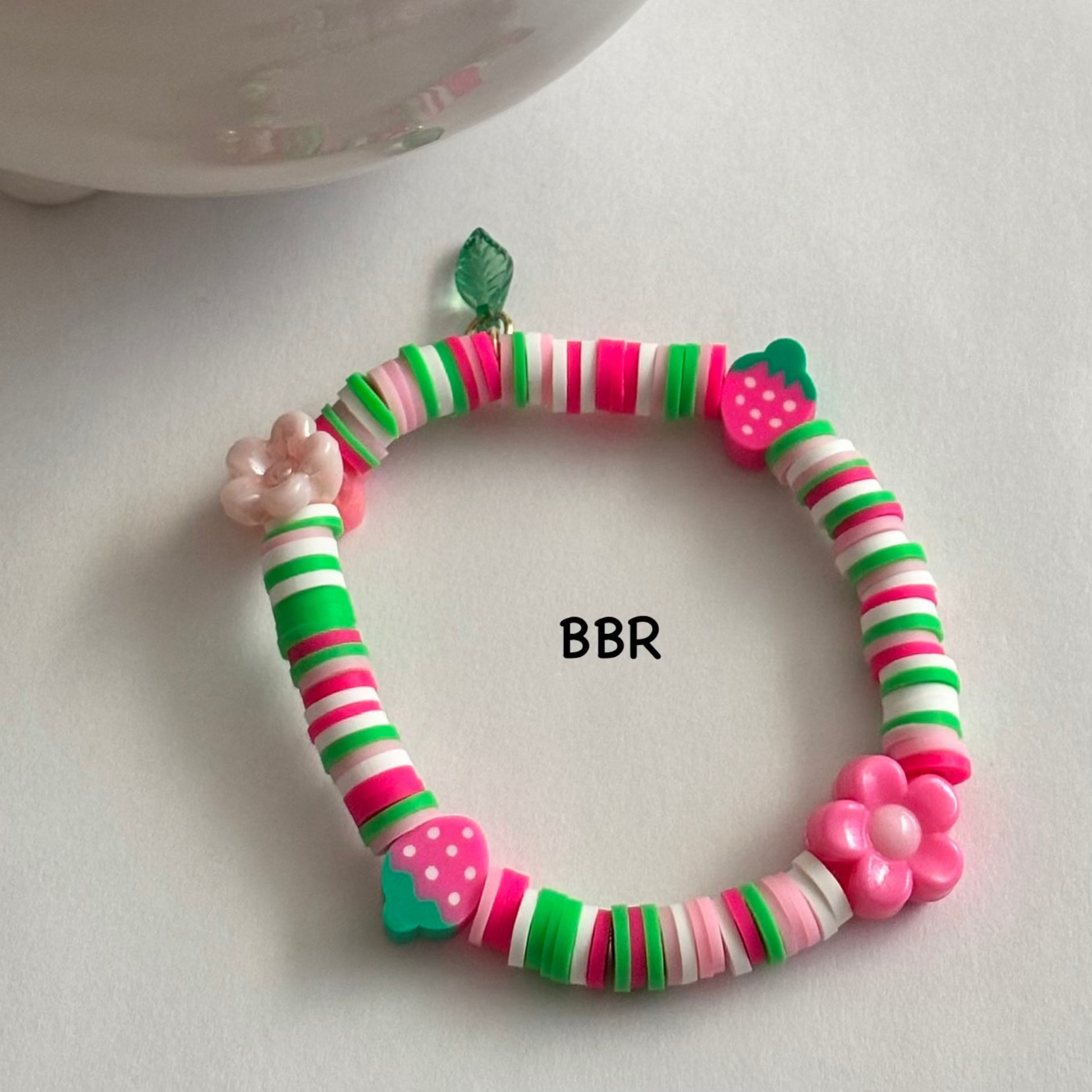 Handmade heishi clay bead bracelet with flower and strawberry beads. 