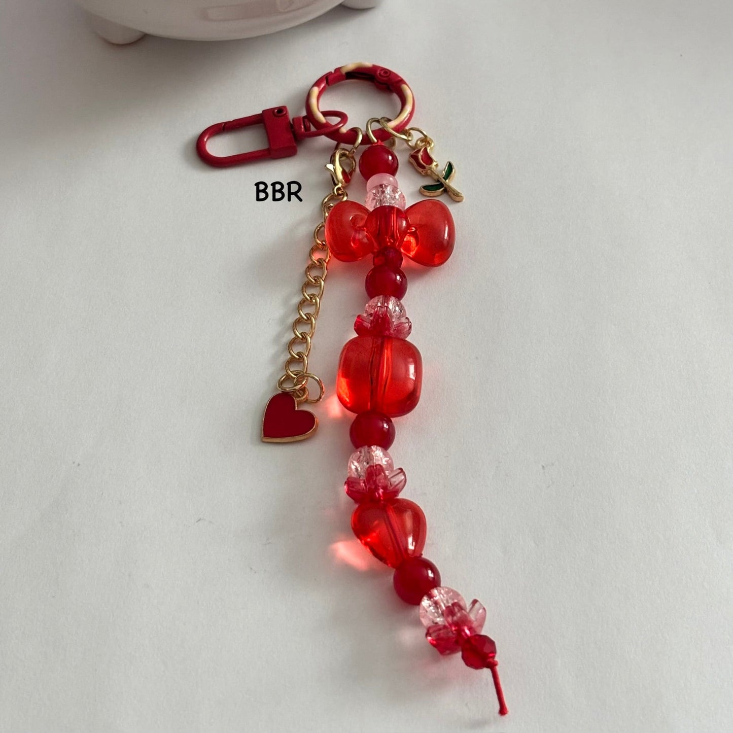 Handmade Red beaded bag charm with heart  and flower charms.