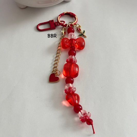 Handmade Red beaded bag charm with heart  and flower charms.